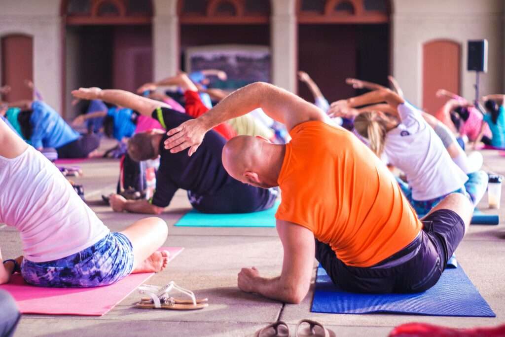 Man Doing Yoga in a Class