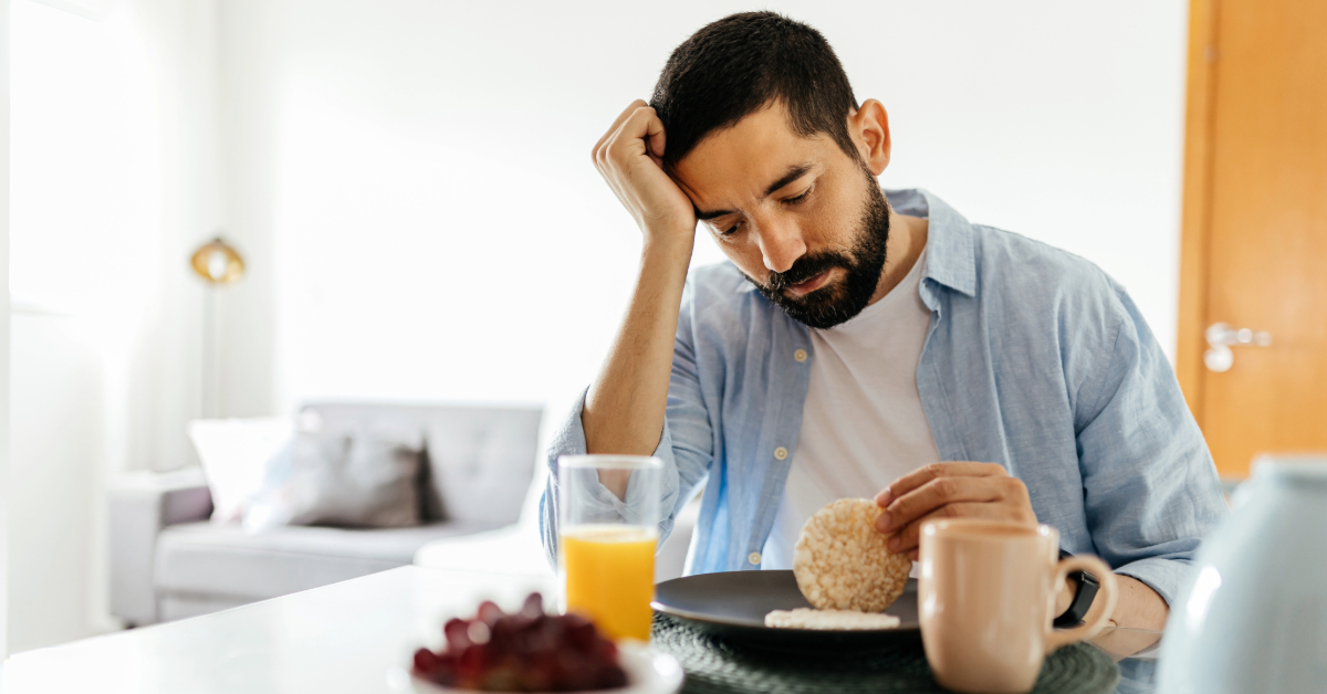 man looks at his breakfast wondering about the relationship between food and depression